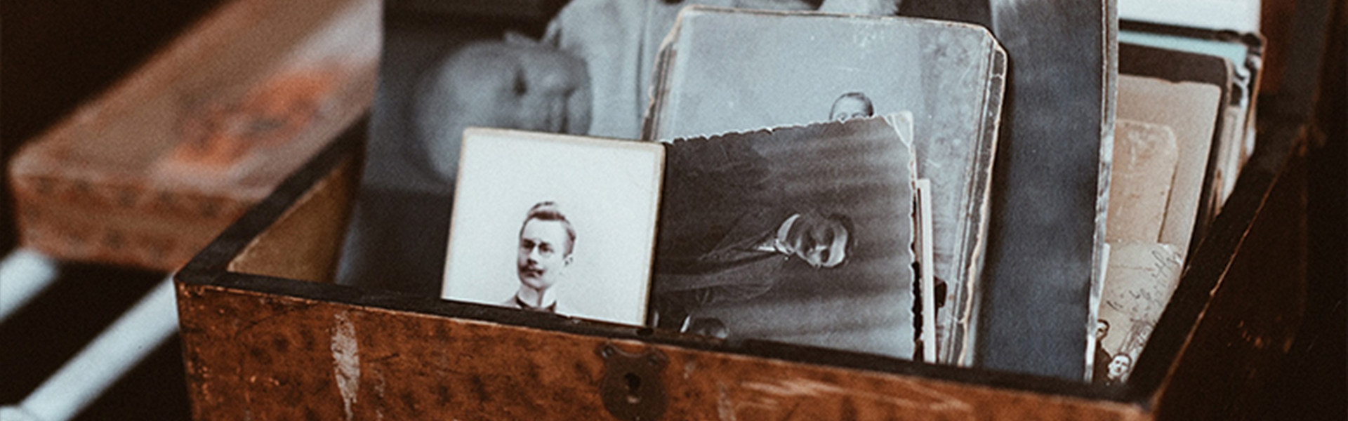 memory box full of black and white photos of a man and his loved ones