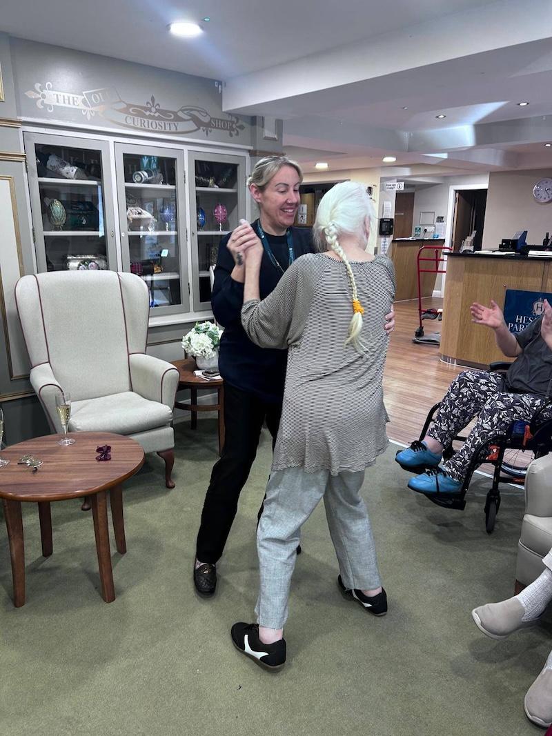 one of our residents dancing with our manager in the lounge