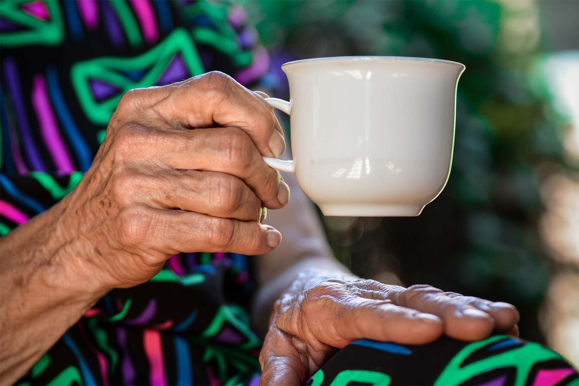 resident holding cup of tea