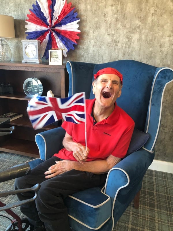 happy resident holding flag