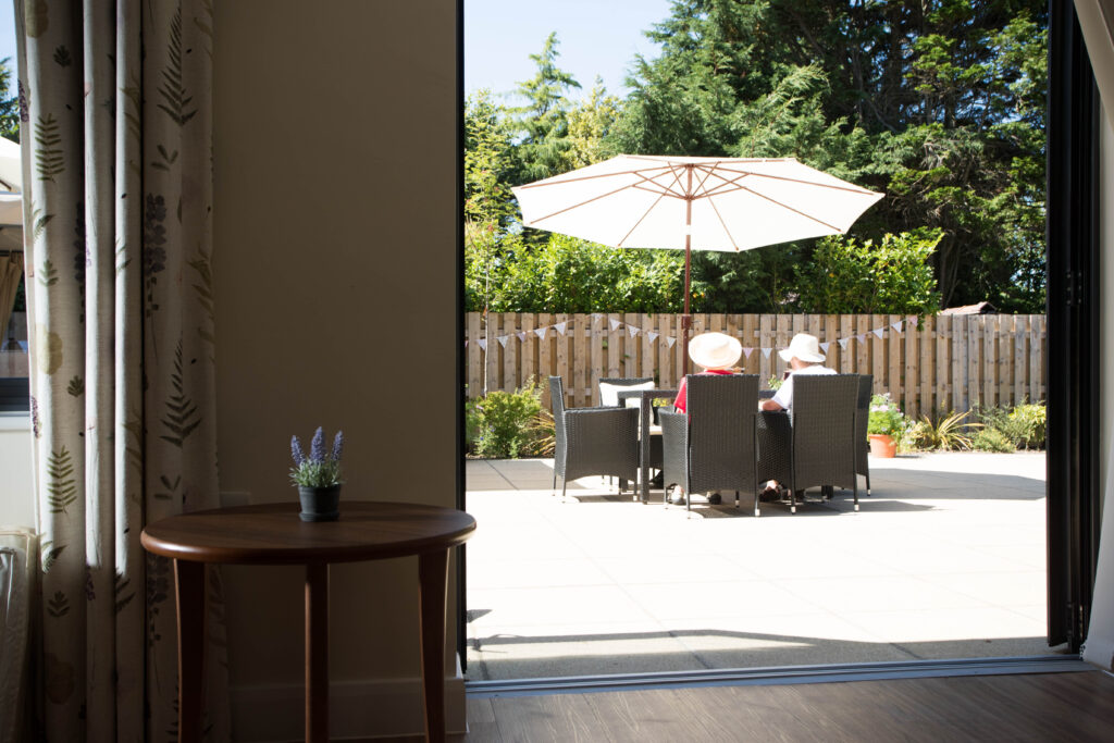 residents enjoying the sun on the patio