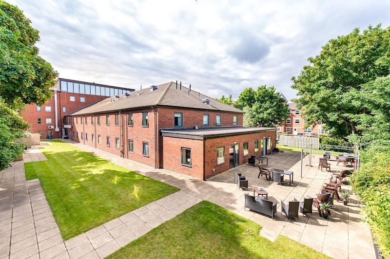 outdoor view of the home with seating and garden areas