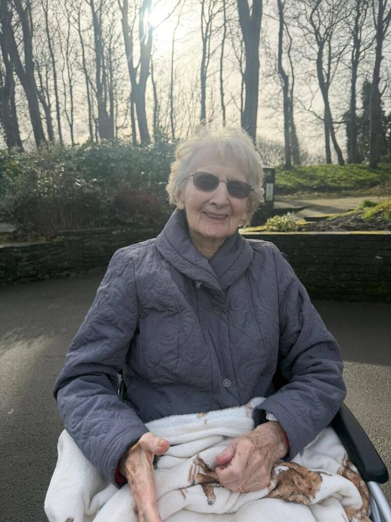 resident sat in a wheelchair in the local park