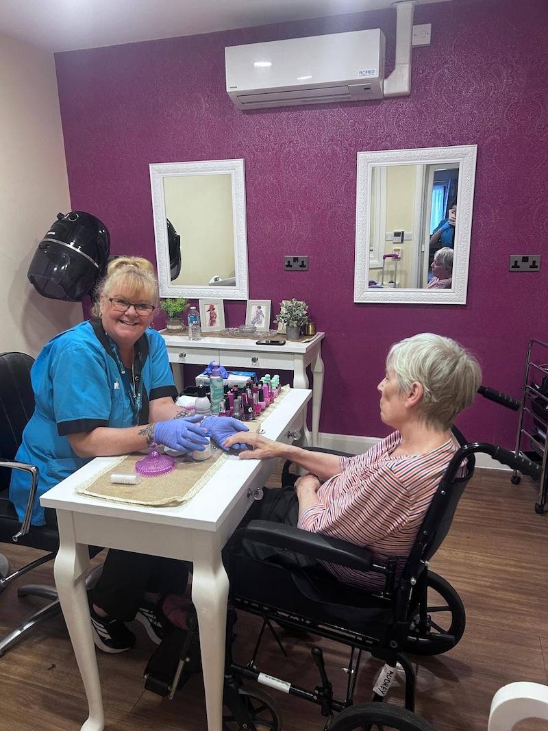 female resident sat down having her nails done