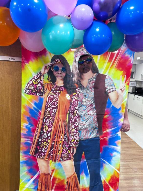 people posing behind a photo board