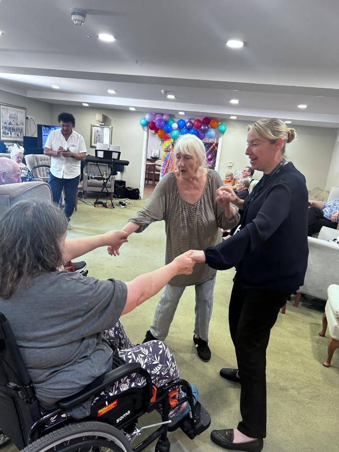 three ladies dancing at a party