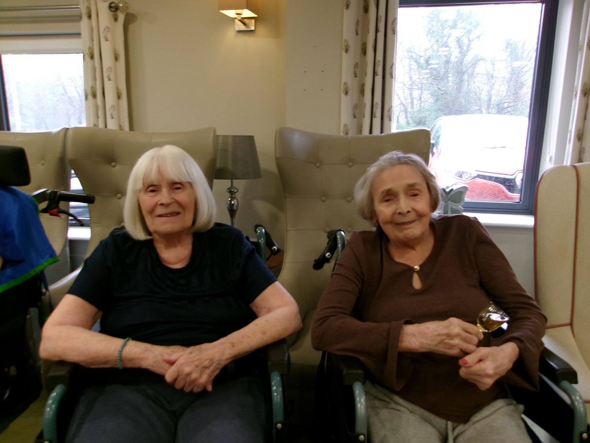 two older ladies sat down in wheelchairs