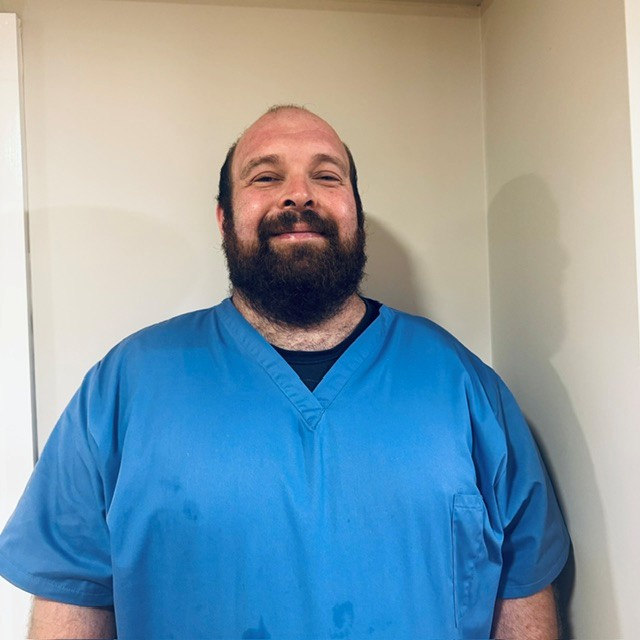 man standing for staff photo